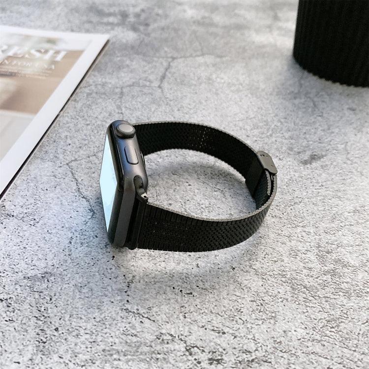 Buckle style steel replacement watchband for Apple Watch, shown on a black watch next to a magazine.