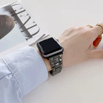 Ceramics replacement strap for Apple Watch seen on wrist with a stylish rhombic grid design.